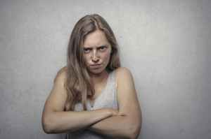 woman in gray tank top looking furious